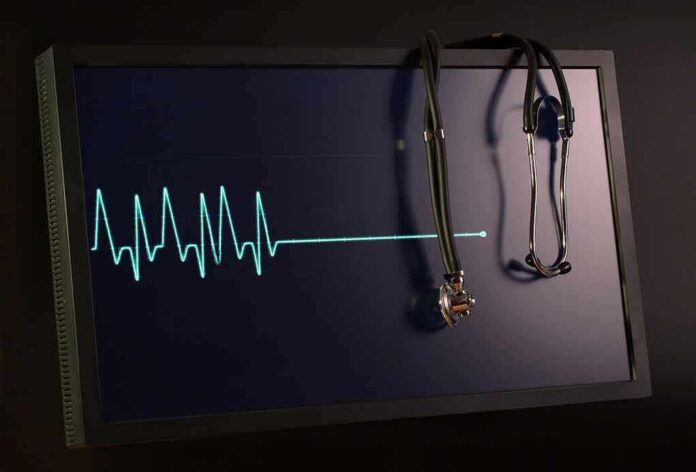shutterstock_607954508 stethoscope hanging on monitor with flatlined ecg